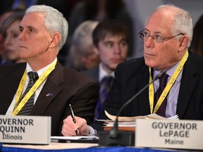 Illinois Democratic Gov. Pat Quinn, right, makes notes as Indiana Republican Governor Mike Pence listens during the National Governors Association Winter Meeting in Washington, February 22, 2014. (REUTERS/Mike Theiler)