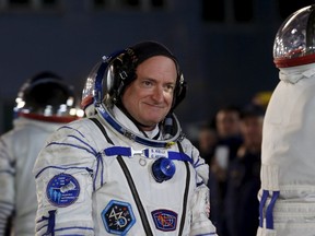 NASA astronaut Scott Kelly walks after donning space suit at the Baikonur cosmodrome March 27, 2015. (REUTERS/Maxim Zmeyev)