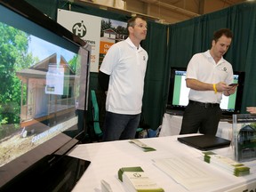 Shaun, left, and Robert Morgan at their Morgan Homes Inc. booth at the Quinte Home Builders' Association Home and Lifestyle show Friday in Belleville.