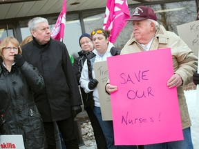 People gather outside the office of Carleton-Mississippi Mills MPP Jack MacLaren to protest government cuts to local hospitals. Photo taken on Friday, March 27, 2015. (DANI-ELLE DUBE/Ottawa Sun/QMI AGENCY)
