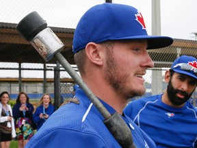 Jose Bautista and (right) Josh Donaldson have spent a lot of time together this spring, including joking around with a lizard. (Stan Behal/Toronto Sun)