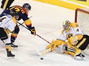 Sarnia Sting goalie Taylor Dupuis makes a save on Taylor Raddysh of the Erie Otters in the first period of Game 2 of the OHL western quarterfinal on March 27 at Erie Insurance Arena. (JACK HANRAHAN, Special to QMI Agency)