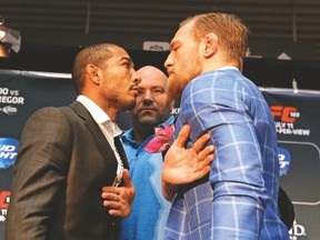 UFC president Dana White has to step in between featherweight champion Jose Aldo (left) and challenger Conor McGregor at a press conference yesterday at the Eaton Centre. (MICHAEL PEAKE/Toronto Sun)