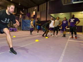 Daryl Waud a Western defensive tackle, who is ranked high for the CFL draft works on flexibility and mobility during a pre-CFL combine camp being held at Western's Thompson Arena in London, Ont. on March 23, 2015. (Mike Hensen/QMI Agency)