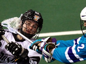 The Edmonton Rush's Curtis Knight is hit by the Rochester Knighthawks' Paul Dawson during NLL action at Rexall Place, in Edmonton, Alta., on Saturday Feb. 1, 2014. David Bloom/Edmonton Sun/QMI Agency