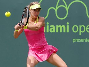 Eugenie Bouchard hits a backhand against Tatjana Maria during the Miami Open at Crandon Park Tennis Center Saturday in Key Biscayne, Fla. (Geoff Burke/USA TODAY Sports)