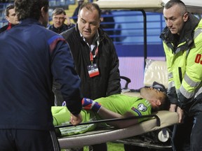 Russia’s goalkeeper Igor Akinfeev lies on a stretcher while being transported during the Euro 2016 qualifying match against Montenegro in Podgorica March 27, 2015. (REUTERS/Stringer)