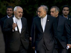Iranian Foreign Minister Javad Zarif (L) talks with Head of the Iranian Atomic Energy Organization Ali Akbar Salehi after an afternoon meeting with U.S. Secretary of State John Kerry and U.S. officials at the Beau Rivage Palace Hotel in Lausanne March 27, 2015. 
Major powers and Iran were pushing each other for concessions on Friday ahead of an end-March deadline for a preliminary nuclear deal, with Tehran demanding an immediate end to sanctions and freedom to continue sensitive atomic research, officials said.    REUTERS/Brendan Smialowski/Pool