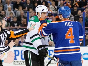 Dallas Stars' Jamie Benn (14) grabs Edmonton Oilers' Taylor Hall (4) during second period NHL hockey game action in Edmonton, Alberta March 27, 2015.  REUTERS/Amber Bracken