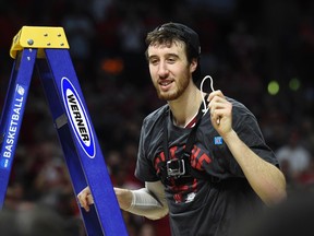 Wisconsin’s Frank Kaminsky cuts the net after the Badgers defeated Arizona 85-78 on Saturday to reach the Final Four. (USA TODAY SPORTS)