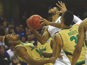 Kentucky Wildcats guard Andrew Harrison goes up for a shot over Notre Dame Fighting Irish guard Demetrius Jackson during Saturday night’s regional final. (USA TODAY SPORTS)