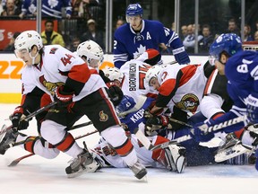 Players from both Toronto and Ottawa pile on Senators goaltender Craig Anderson on Saturday night at the Air Canada Centre. (USA Today Sports)