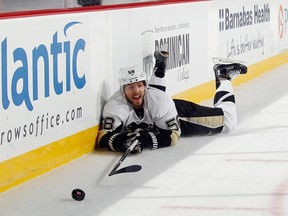 Kris Letang #58 of the Pittsburgh Penguins is tripped up late in the third period against the New Jersey Devils at the Prudential Center on March 17, 2015 in Newark, New Jersey. (Bruce Bennett/Getty Images/AFP)