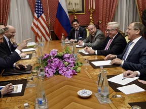 U.S. Secretary of State John Kerry (left) and Russia's Foreign Minister Sergei Lavrov (right) share a light moment before a meeting at the Beau Rivage Palace Hotel in Lausanne, Switzerland, March 29, 2015. (BRENDAN SMIALOWSKI/Pool/Reuters)