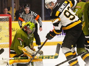 North Bay Battalion goalie Jake Smith makes a blocker save as Kingston Frontenacs forward Sam Bennett tries to get his stick on the puck during the first period of OHL Eastern Conference quarter-final playoff action Sunday afternoon at the Memorial Gardens in North Bay. (Dave Dale/QMI Agency)