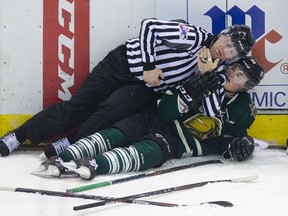 A linesman ends up on top of London Knights? Drake Rymsha after breaking a full line scuffle during the OHL playoff game against the Kitchener Rangers at Budweiser Gardens on Sunday. (DEREK RUTTAN, The London Free Press)