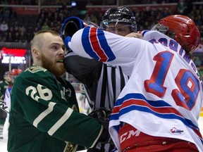 An official breaks up a scuffle between London Knights? Tait Seguin and Kitchener Rangers? Brandon Robinson during Game 2 of their OHL Western Conference quarterfinal series Sunday. (DEREK RUTTAN, The London Free Press)