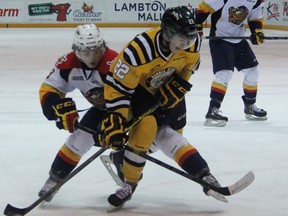 Kyle Maksimovich of the Erie Otters and Sarnia Sting defenceman Jake O'Donnell battle for puck position during Game 3 of the Ontario Hockey League Western Conference quarter-final series at RBC Centre in Sarnia Sunday night. (Terry Bridge, The Observer)