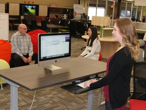 Local office worker Justine Klinkhamer tries out a standing desk in Lovers atWork Office Furniture's London showroom.