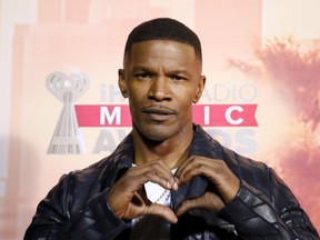 Actor and the evening's host Jamie Foxx makes a heart with his hands as he poses backstage at the 2015 iHeartRadio Music Awards in Los Angeles, California, March 29, 2015. REUTERS/Danny Moloshok