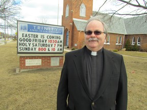 Canon Vicars Hodge stands on the front lawn of Trinity Anglican Church on Monday March 30, 2015 in Sarnia, Ont. Easter Week activities at the church will include a celebration of the Great Vigil of Easter, Saturday, beginning at 7 p.m. (Paul Morden/Sarnia Observer/QMI Agency)