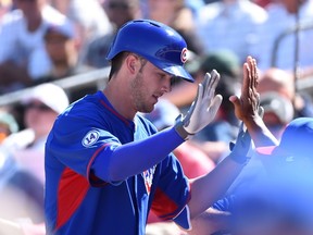 Kris Bryant of the Chicago Cubs celebrates with teammates after hitting a home run against the Oakland Athletics in a Cactus League game at HoHokam Stadium on March 24, 2015 in Mesa, Ari. (Norm Hall/Getty Images/AFP)