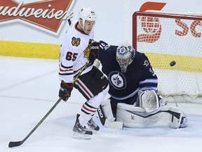 Chicago Blackhawks forward Andrew Shaw is parked in front of Winnipeg Jets goaltender Ondrej Pavelec as a shot goes just wide during NHL action at MTS Centre in Winnipeg, Man., on Sun., March 29, 2015. Kevin King/Winnipeg Sun/QMI Agency