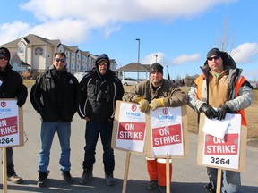 Unifor 3264 members staff a secondary picket line at the Best Western Hotel in Woodstock, where replacement workers and Carmeuse management are believed to be staying. From left to right, Ken Mitchell, Jody Slade, Darryl Bruce, Alec Lockhart and Matt Marsh. (Megan Stacey, Sentinel-Review)