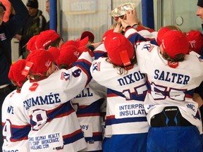 Members of the Kingston Canadians gather around the Ontario Minor Hockey Association minor atom AA championship trophy in their brand-new championship hats after they downed the Kent Cobras 6-3 to capture the six-point series, 6-4, on Sunday at Centre 70. (Tim Gordanier/The Whig-Standard)