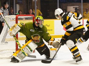 Kingston Frontenacs' Juho Lammikko, right, reaches for the puck as teammate Ryan Verbeek watches and Battalion goalie Jake Smith moves to get into position during OHL Eastern Conference playoff action in North Bay on Sunday. Smith dove across the crease to make the save.
(Dave Dale/QMI Agency)