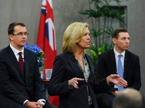 Tory leadership hopeful  Christine Elliot is pictured speaking recently to   to party members in Bowmanville. Candidates  Monte McNaughton (L) and Patrick Brown (R) are also seeking the leadership. (QMI AGENCY PHOTO)