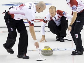 Canada skip Pat Simmons delivers a rock with lead Nolan Thiessen (L) against Russia during the eighth draw of the World Men's Curling Championships in Halifax, Nova Scotia, March 30, 2015.    REUTERS/Mark Blinch