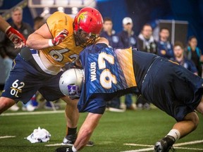 Daryl Waud of the Western Mustangs gets twisted up during a drill against offensive linemen at the CFL combine in Toronto. (Johany Jutras/CFL.ca)