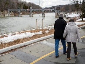 A couple walk past the broken Springbank Dam in London. (Free Press file photo)