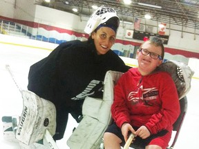 Local goalie coach Kira Hurley with student and fan Cole Perry. (Submitted photo)