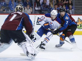 Ryan Nugent-Hopkins shoots the puck against Colorado Avalanche center John Mitchell and goalie Semyon Varlamov Monday in Denver. (USA TODAY SPORTS)
