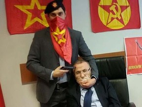 This picture posted online by the Turkish Marxist-Leninist left wing organization, the DHKP-C, shows an alleged militant from the group holding a gun to the head of prosecutor Mehmet Selim Kiraz in Istanbul, March 31, 2015. (Halkin Sesi TV/Handout via Reuters)