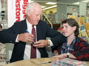 Gordie Howe gives young fans a lesson in using your elbows during an autograph session at the Worlds Biggest Bookstore in Toronto on Oct. 25, 1988. (Craig Robertson/Toronto Sun/QMI Agency)