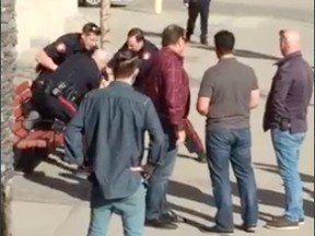 A screenshot of video that captured an arrest of a man who refused to pay a bar tab on 17 Ave. S.W.