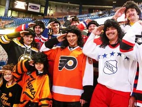 A group of Jaromir Jagr fans give the "Jagr Salute"  while wearing mullets and the jersey's of his former teams prior to the start of the Edmonton Oilers and New Jersey Devils game at Rexall Place, in Edmonton Alta., on Thursday Nov. 20, 2014. (David Bloom/Edmonton Sun/QMI Agency)