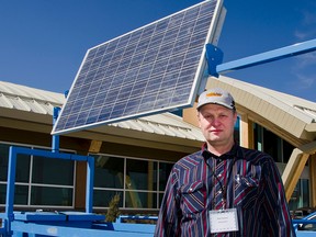 Karl Janzen, a local farmer and Sundog Solar dealer, stands in front of a sun-powered off-stream watering system during the MD of Pincher Creek Agricultural Service Board's open house on March 27, 2015. The board purchased the unit and plans to demonstrate its capabilities at area ranches. According to Janzen the watering system can provide clean drinking water for hundreds of cattle while protecting riparian areas. John Stoesser photo/QMI Agency.