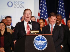 United States Olympic Committee president Lawrence F. Probst III flanked by Boston mayor Martin J. Walsh (right) , talks about the USOC selecting Boston as its applicant city to host the 2024 Olympic and Paralympic Games at the Boston Convention Center and Exhibition Center.  Greg M. Cooper-USA TODAY Sports