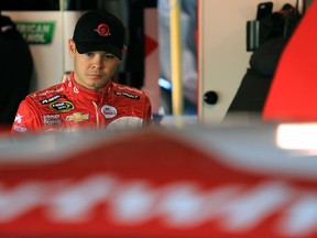 Kyle Larson, driver of the #42 Target Chevrolet, stands in the garage area during practice for the NASCAR Sprint Cup Series STP 500 at Martinsville Speedway on March 28, 2015. (Daniel Shirey/Getty Images/AFP)
