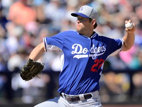 Los Angeles Dodgers starting pitcher Clayton Kershaw pitches against the Seattle Mariners at Peoria Sports Complex on March 15, 2015. (Joe Camporeale/USA TODAY Sports)