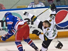 London Knights? Tait Seguin, and his helmet, go flying after a collision with Rangers? Max Iafrate in the first period in Kitchener on Tuesday.  (DEREK RUTTAN, The London Free Press)