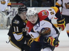 Darren Raddysh of the Erie Otters carries the puck up the ice with Hayden Hodgson of the Sarnia Sting in pursuit. The Ontario Hockey League clubs contested Game 4 of their first-round series at RBC Centre in Sarnia Tuesday night. (Terry Bridge, The Observer)