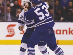 Leafs’ Sam Carrick and Tampa Bay’s J.T. Brown duke it out during last night’s game at the ACC. (MICHAEL PEAKE/Toronto Sun)