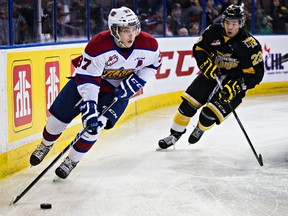Dysin Mayo carries the puck behind the Oil Kings net while a Brandon's Tim McGauley chases him during the first period of Tuesday's game at Rexall Place. (Codie McLachlan, Edmonton Sun)