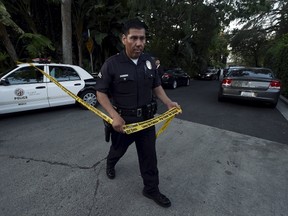 A policeman prepares to block off the street leading to the house of Andrew Getty, the grandson of Getty oil founder J. Paul Getty, in the Hollywood Hills section of Los Angeles, California March 31, 2015. The grandson of billionaire Getty oil founder J. Paul Getty, Andrew Getty, was found dead at age 47 on Tuesday at his home in Los Angeles, the Los Angeles Times reported. REUTERS/Kevork Djansezian