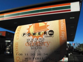 A powerball Lottery ticket is shown in this photo illustration after being purchased at a gas station in San Diego, California, February 10, 2015. Gamblers betting on the multi-state Powerball lottery this week could win one of the biggest jackpots in the game's history, as the total climbed to $485 million on Tuesday, the Powerball website showed. REUTERS/Mike Blake